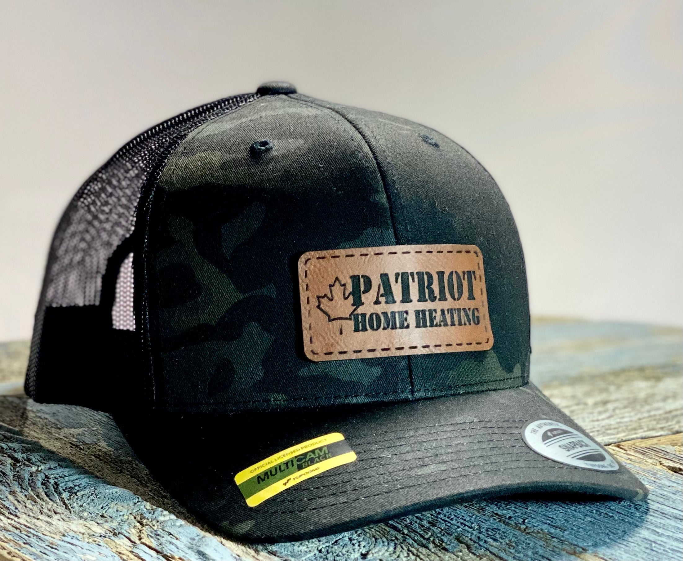 Hat with Patriot home heating logo on a faux leather patch.